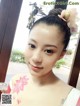 A woman with a flower in her hair is posing for a picture.