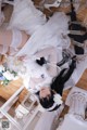 A woman in a wedding dress laying on the floor.